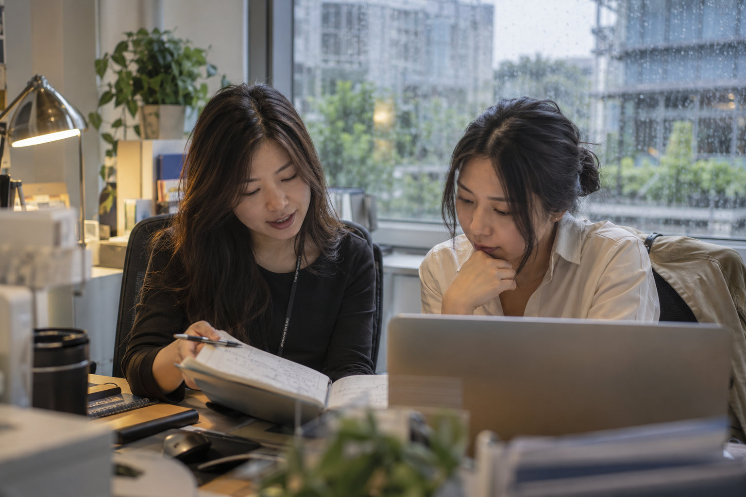 Two professionals reviewing handover details