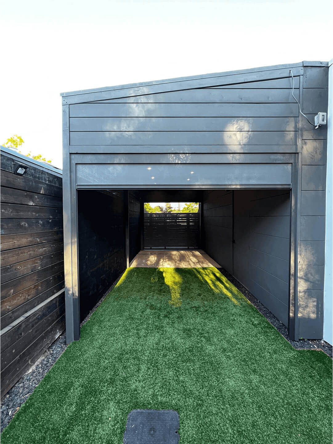 Sturdy dark-framed pergola structure at Sun Vale, built from durable composite or coated metal materials