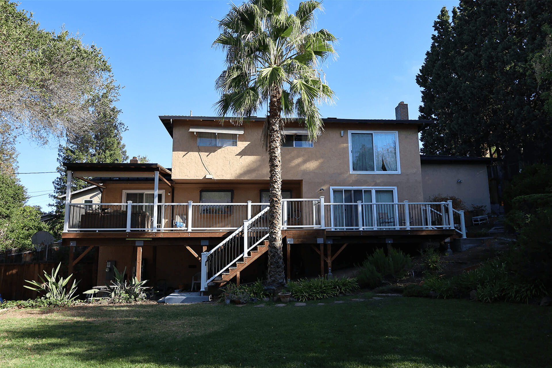 Raised backyard deck with custom railing, creating an outdoor living space for a California home.