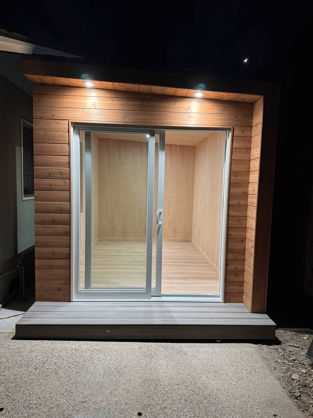 Modern backyard shed with natural wood cladding and a glass door in Sunnyvale, California, in the Bay Area near San Francisco.