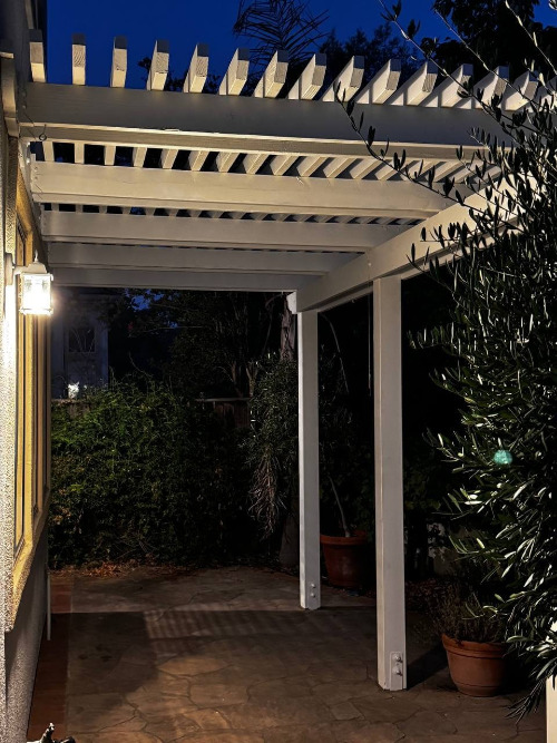Modern backyard pergola with string lighting and a cozy outdoor seating area in San Jose, California