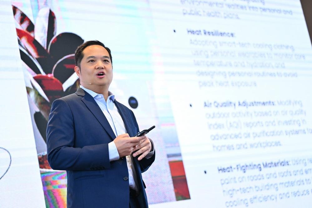 A person in a suit speaking in front of a large screenAI-generated content may be incorrect.