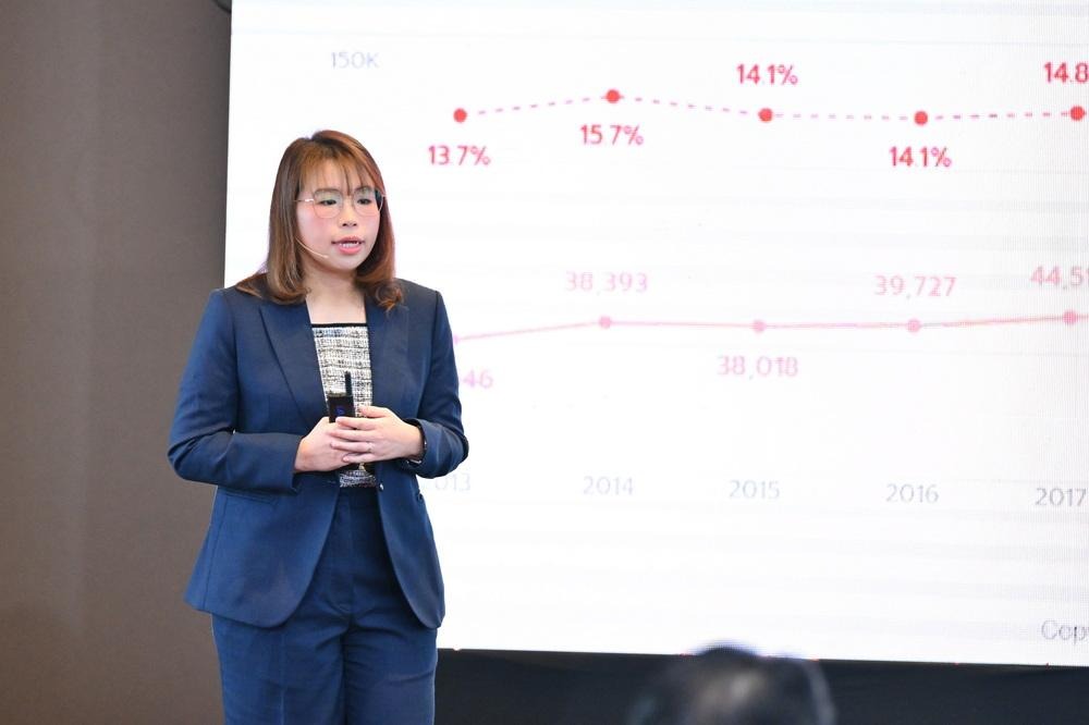 A person in a suit standing in front of a projection screenAI-generated content may be incorrect.