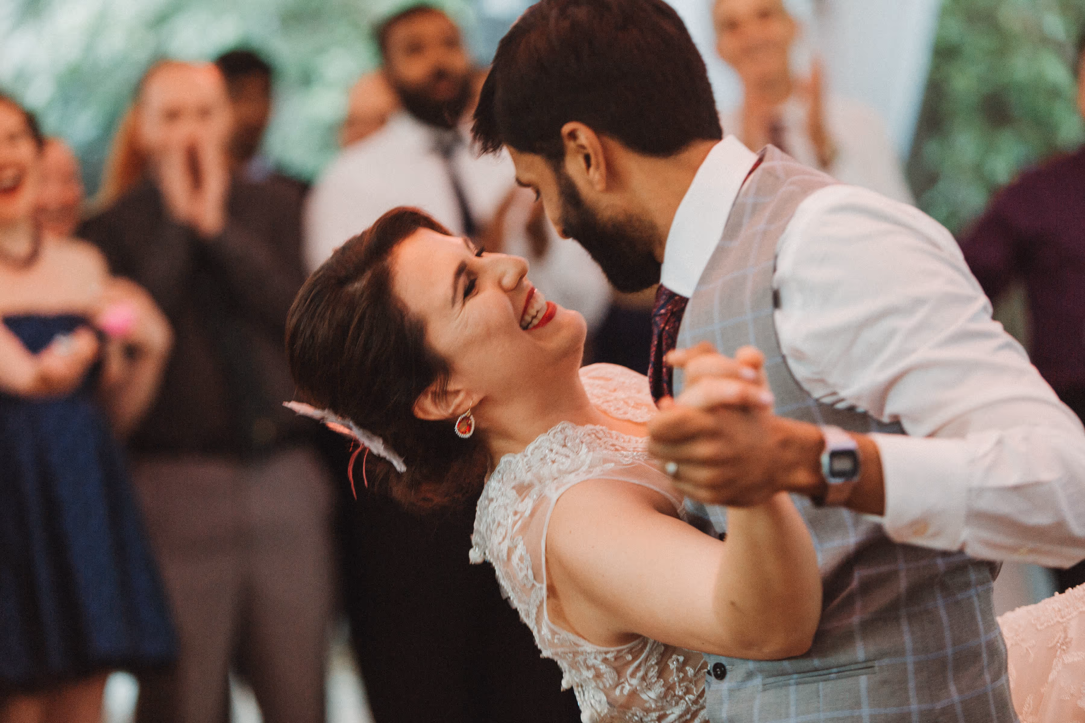 Bride and groom smiling and dancing closely during their wedding celebration.