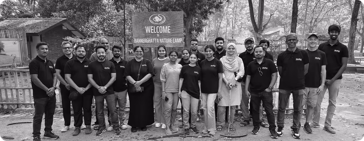 Group of people standing outdoors in front of a Bannergatta Nature Camp welcome sign.