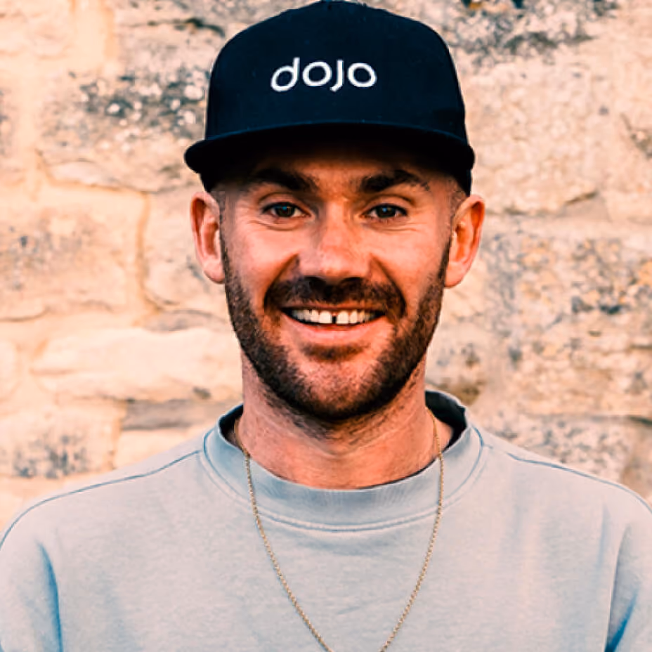 Headshot of Tom Voller, Co-Founder & Managing Director at Dojo Films, wearing a black cap with the Dojo logo