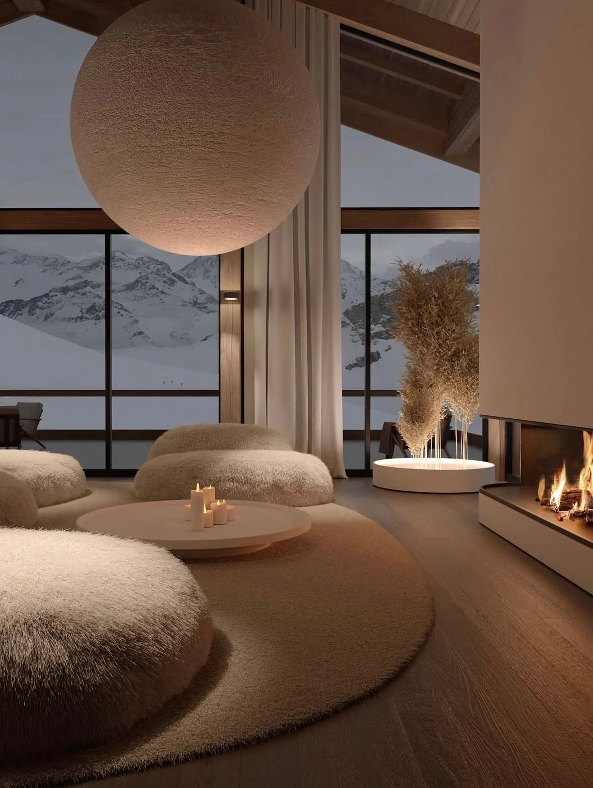 Salon moderne avec grand luminaire sphérique suspendu, poufs moelleux beige, table ronde avec bougies allumées, cheminée et grandes fenêtres offrant une vue sur montagnes enneigées.