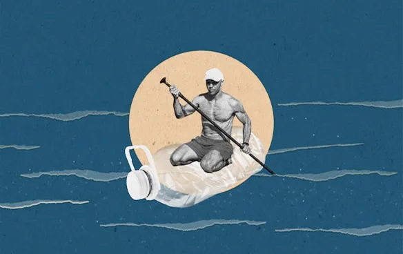 Man paddleboarding while sitting on a large plastic water bottle floating in blue water.