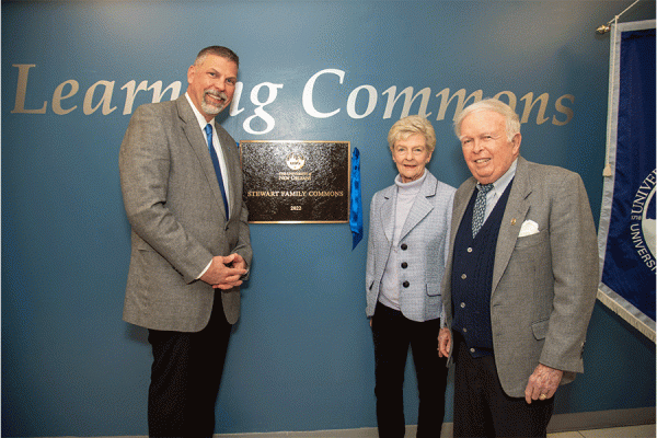 UNO President John Nicklow honors donors Frank and Paulette Stewart at a dedication ceremony in the Earl K. Long Library.