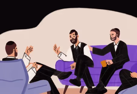 Four men in suits sitting and talking, one on a purple couch and others on chairs.