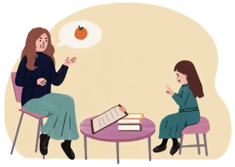 Woman teaching a girl who is pointing, with a speech bubble showing an orange fruit.