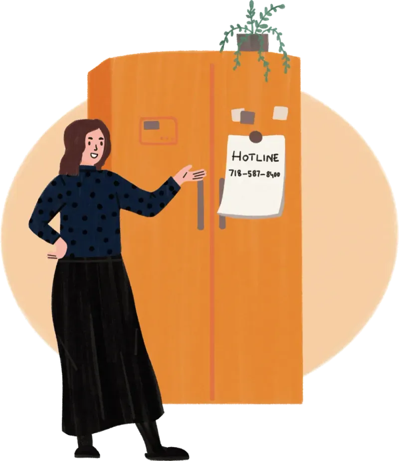 Woman pointing to an orange fridge with a paper note showing a hotline phone number.