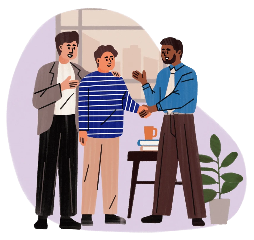 Three men in an office, one shakes hands with another while the third stands smiling.