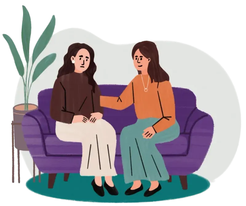 Two women sit on a purple couch, one comforting the other who looks worried, with a plant nearby.