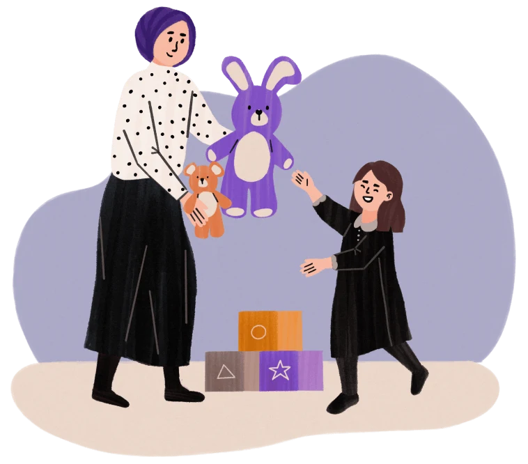 Woman in a hijab giving a purple bunny and bear toy to a smiling child with building blocks nearby.