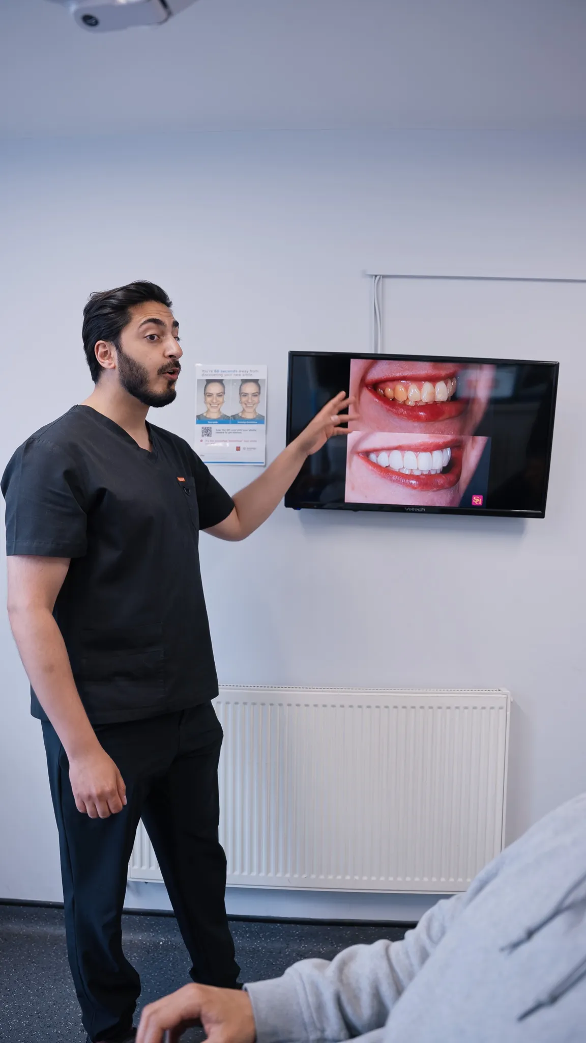 Dr Hamza Mirza with a patient at Sale Dental Spa