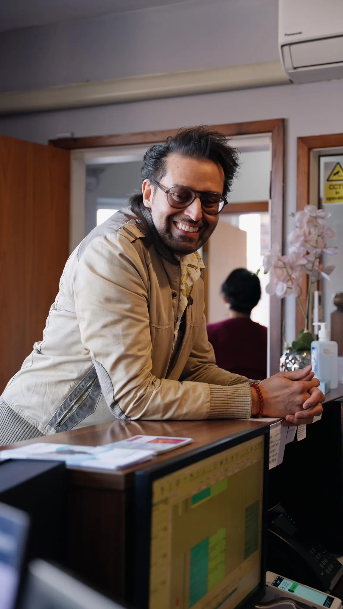 A patient being welcomed at the Sale Dental Spa front desk