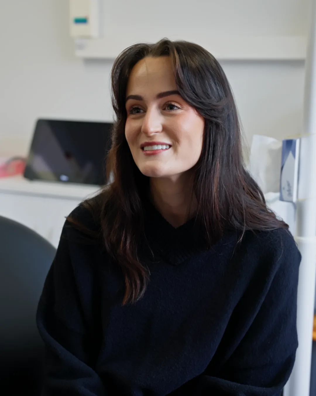 A patient smiling and chatting in the chair at Sale Dental Spa