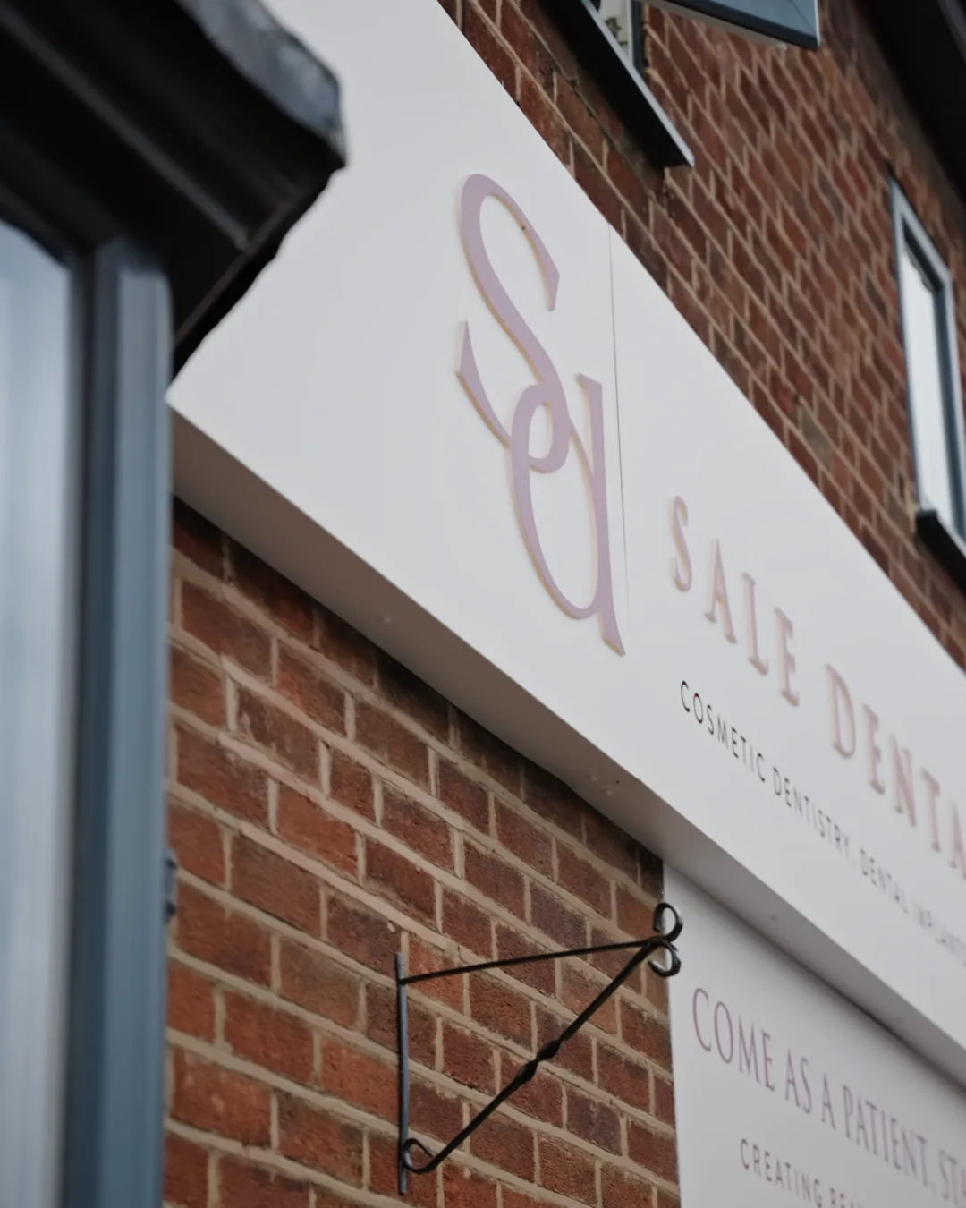 Sale Dental Spa front window with the words come as a patient