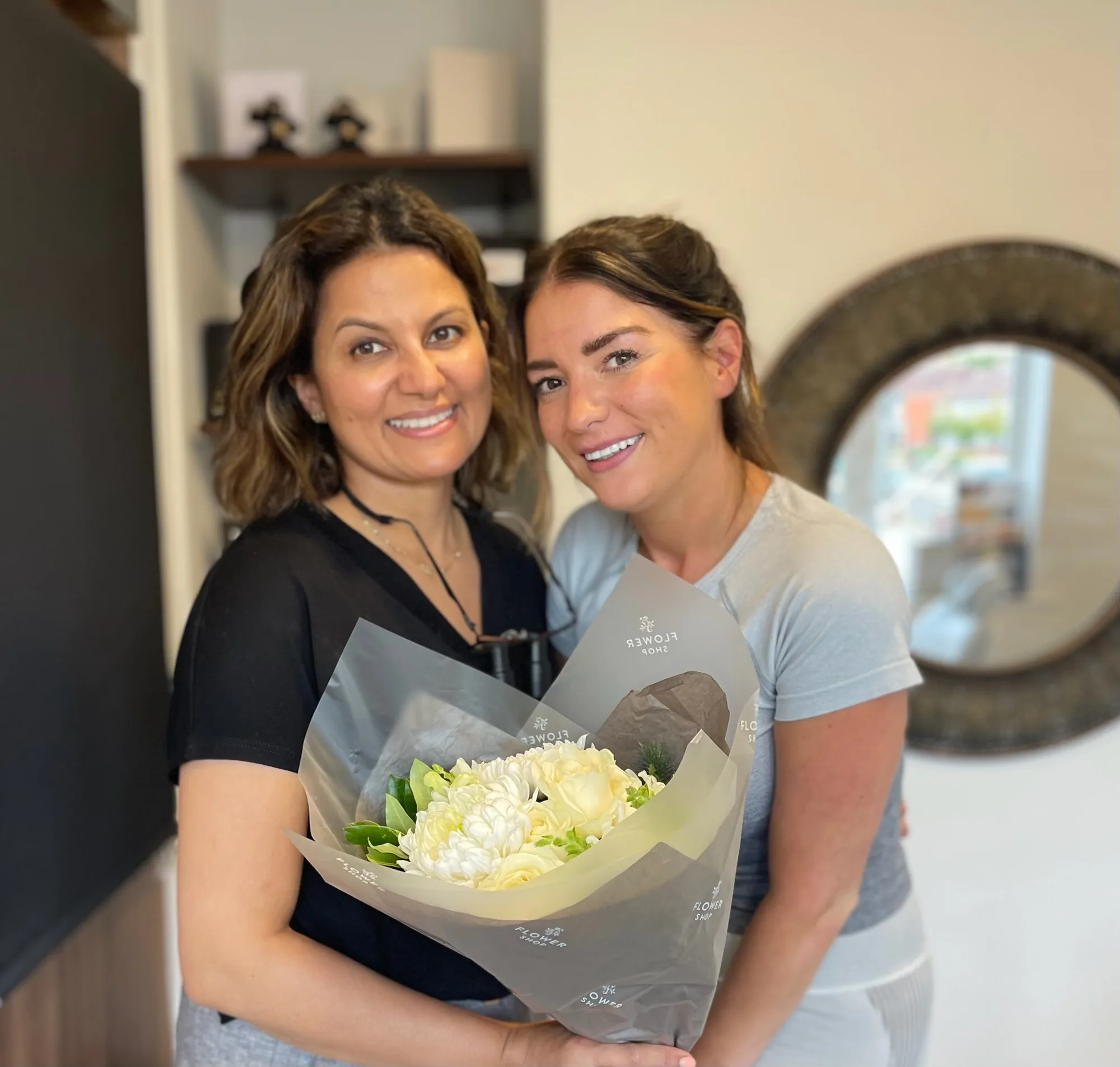 Dr Aisha with a patient holding flowers at Sale Dental Spa