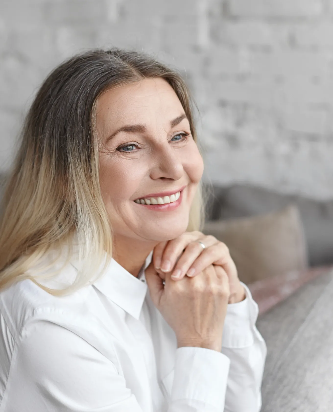 A woman in a white shirt smiling.