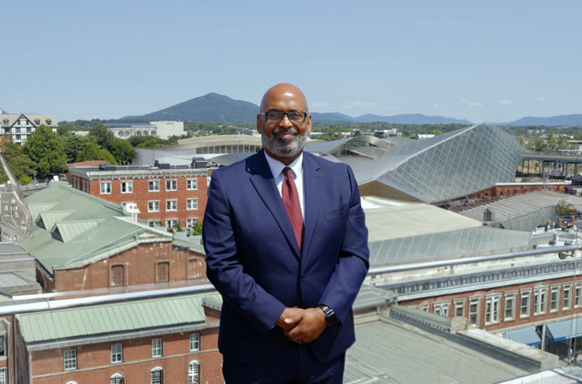 Harvey Brookings in front of a cityscape