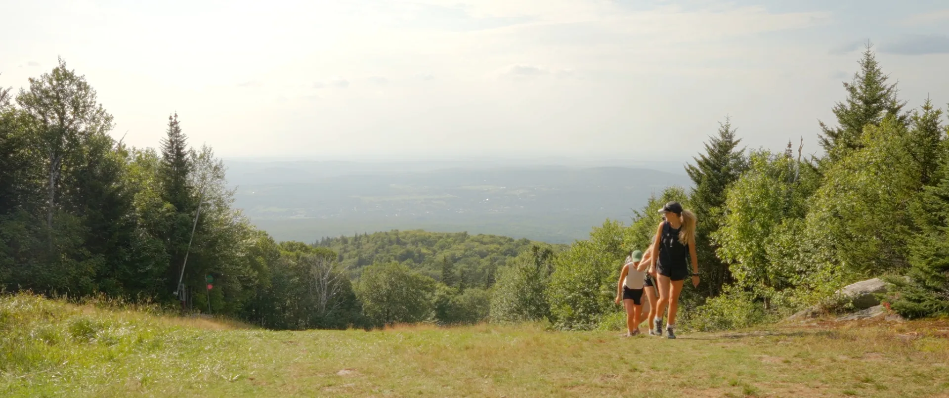 Tente illuminée de l'intérieur à la tombée de la nuit sur le mont Sutton, ambiance plein air estivale