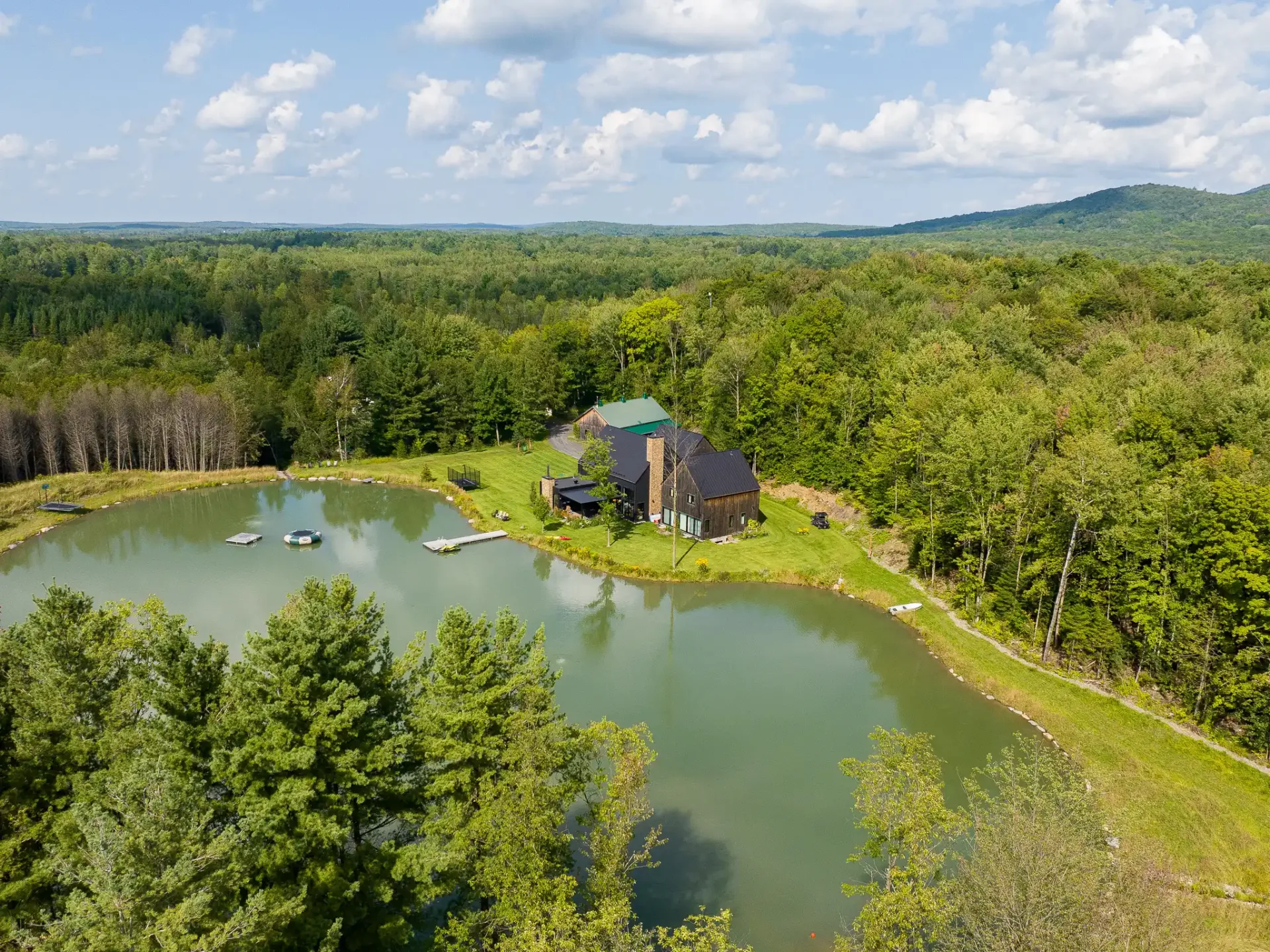 Domaine au bord d'un lac privé, collines boisées à l'horizon