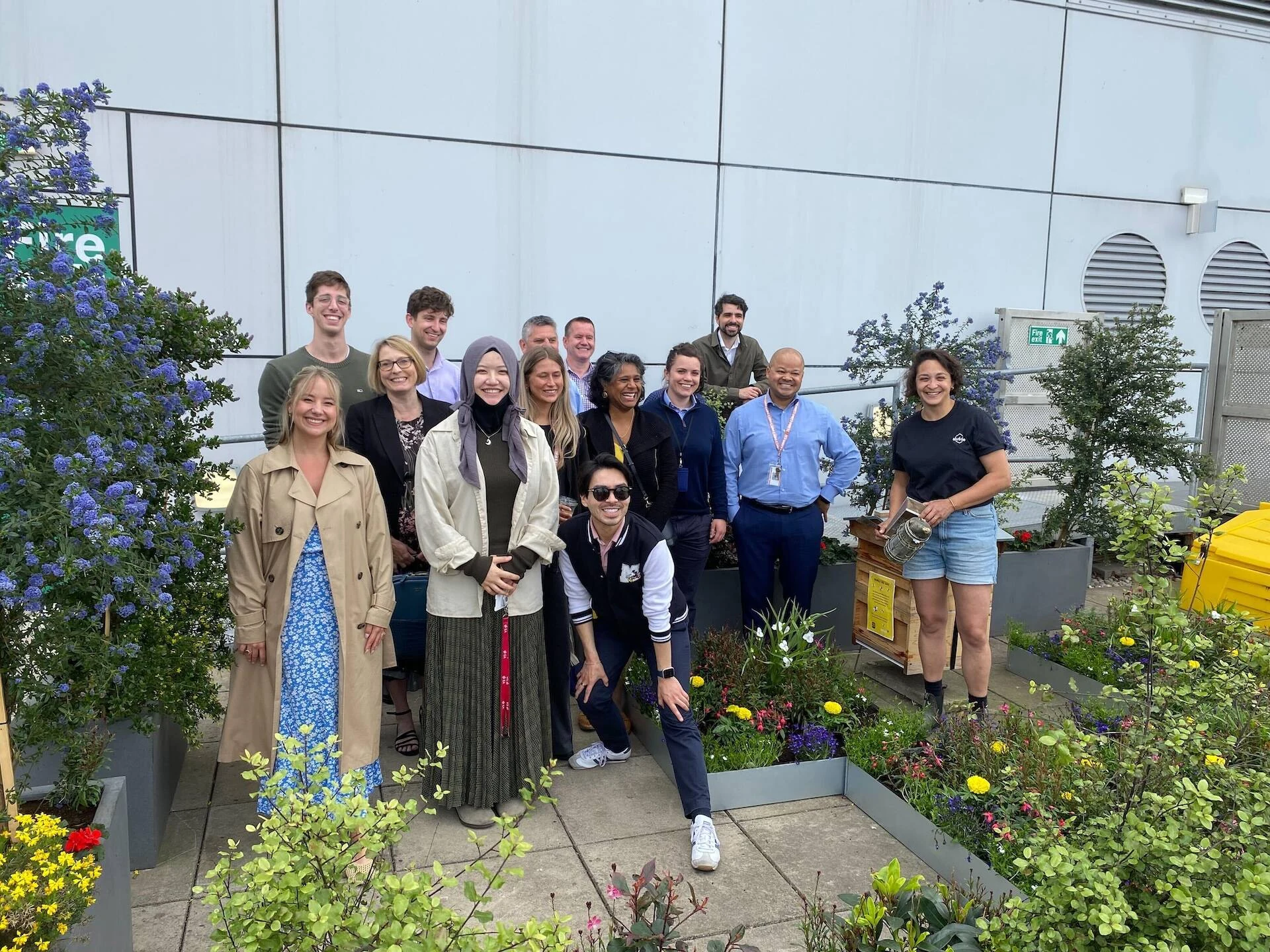 Group photo in a rooftop garden in London with Alvéole