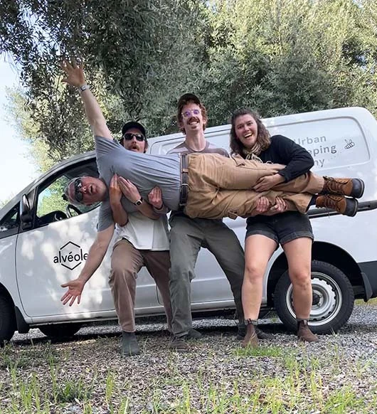 Alvéole team goofing around their branded van