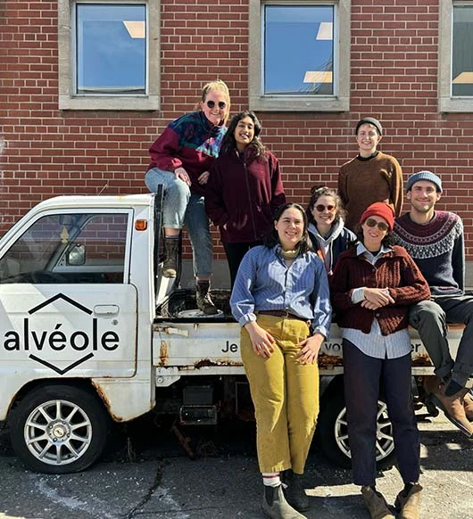 Alvéole team posing on their branded mini truck