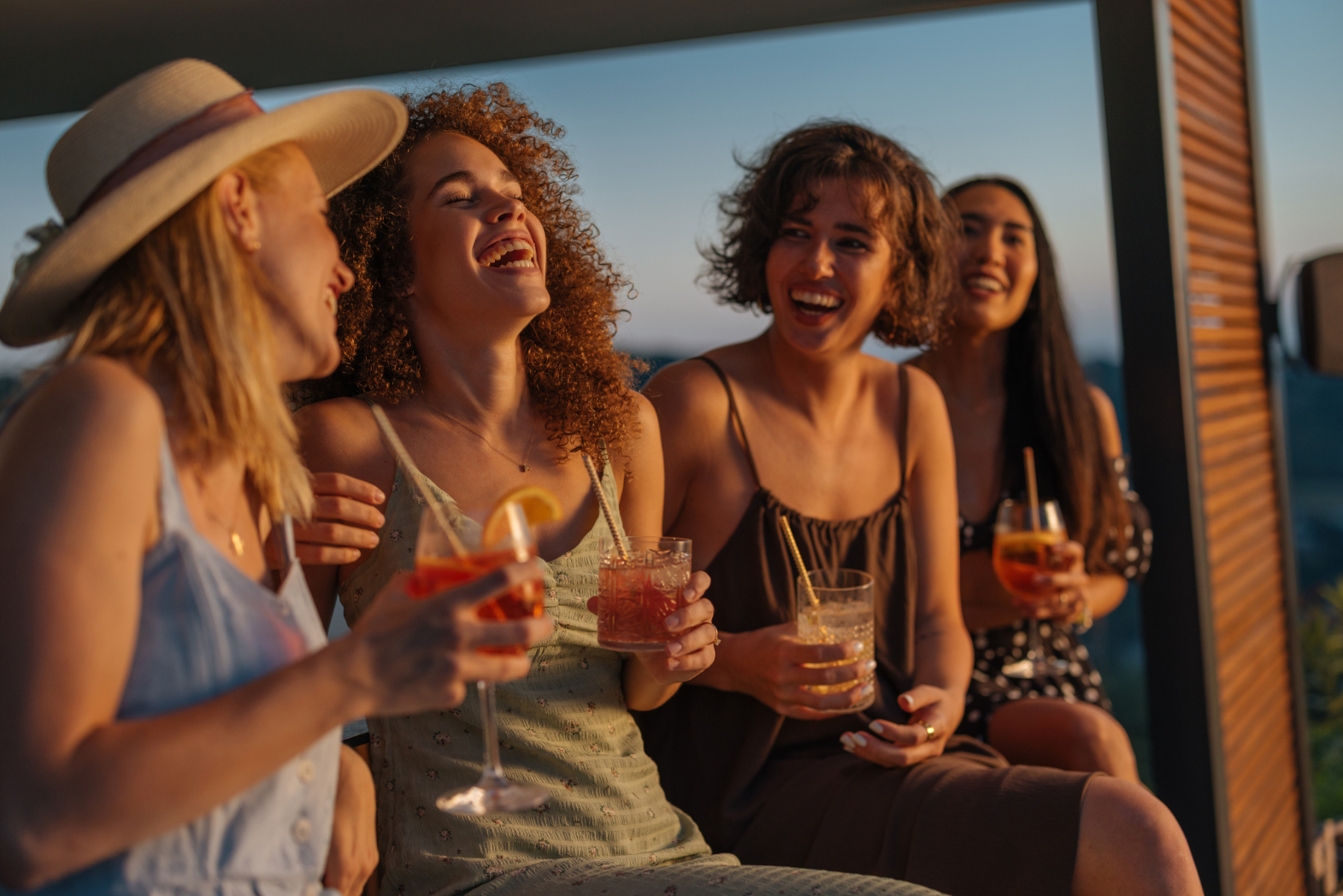Women laughing with drinks stock image