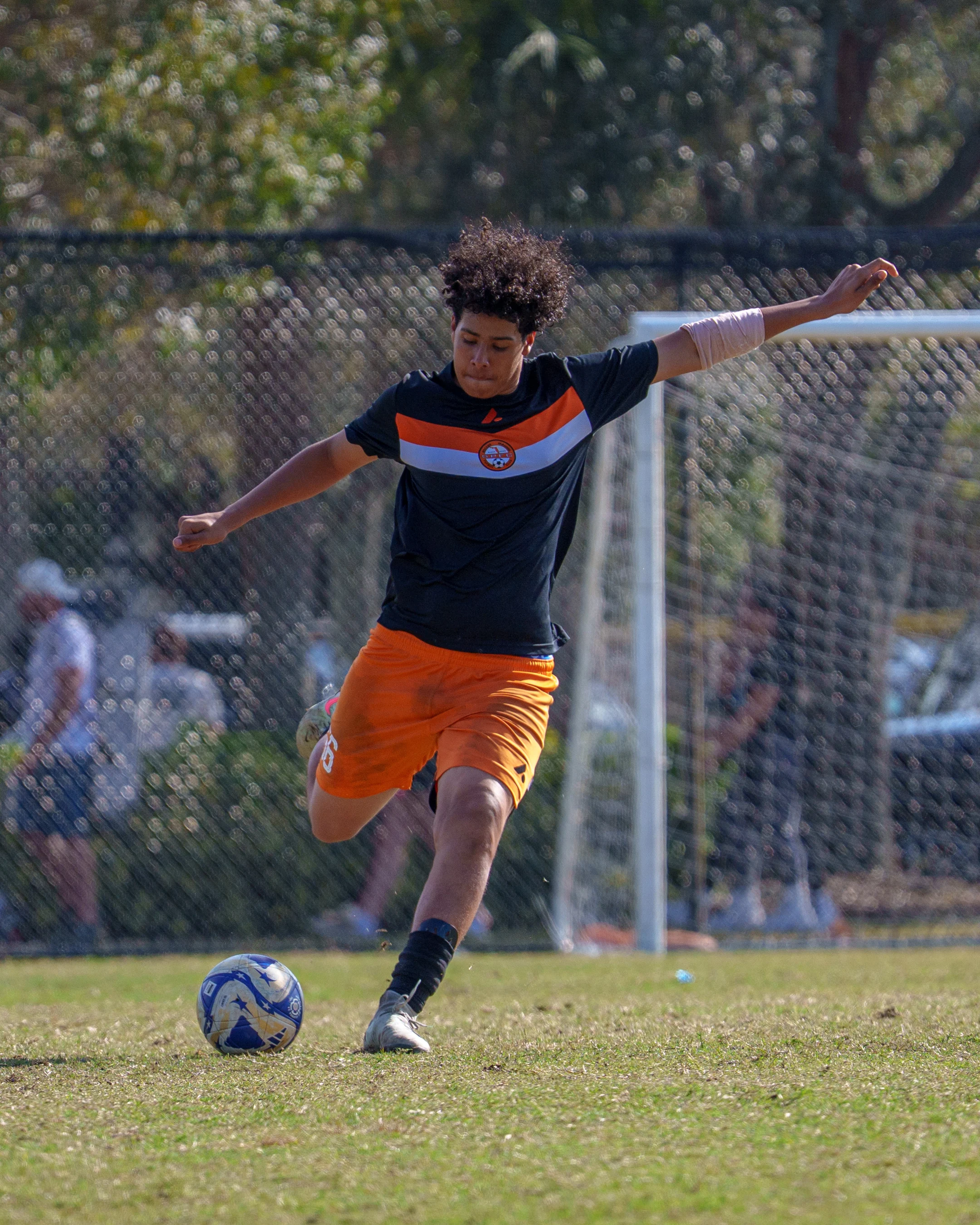 Teen athletes participating in soccer drills.