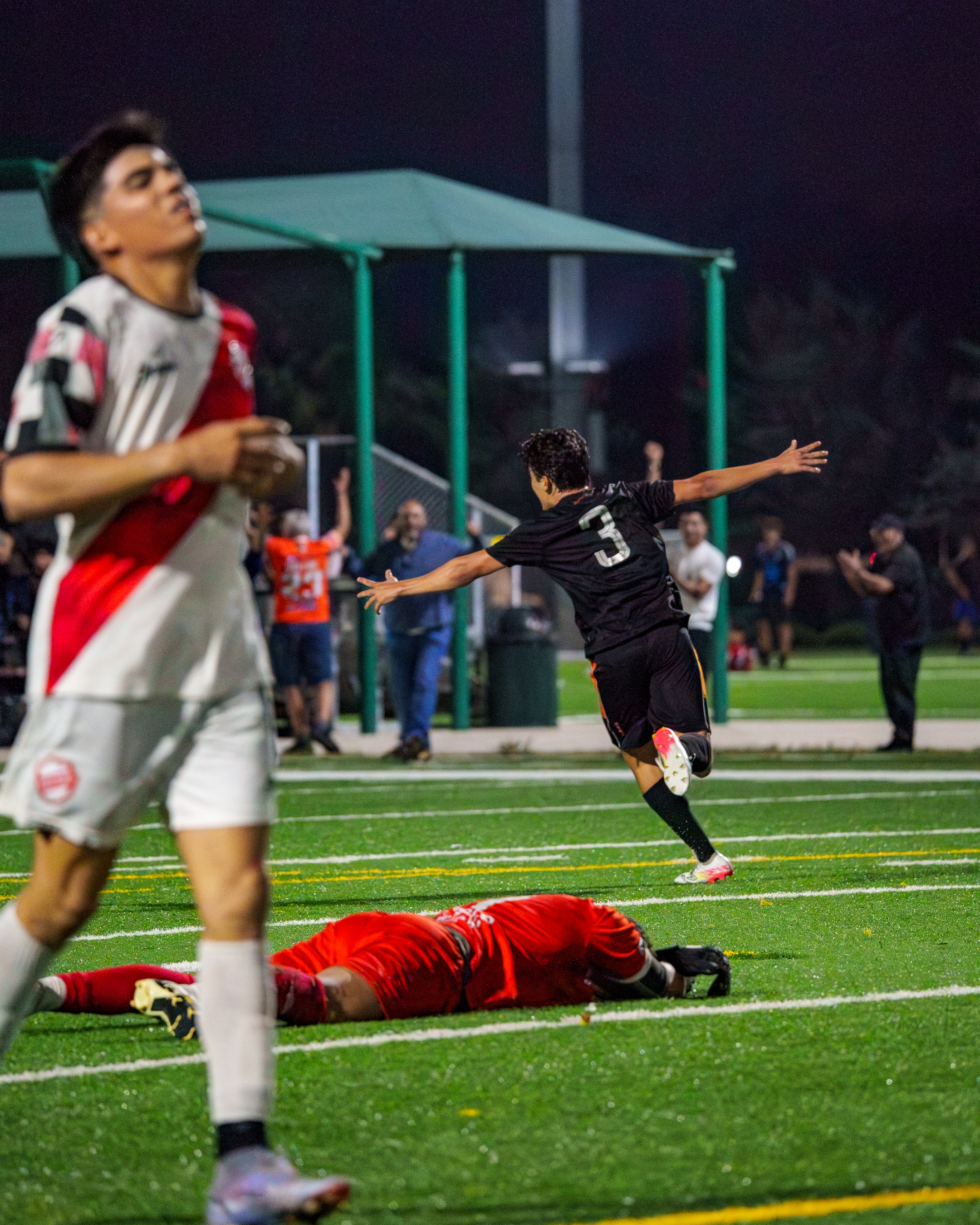 Teen soccer players competing in a match.