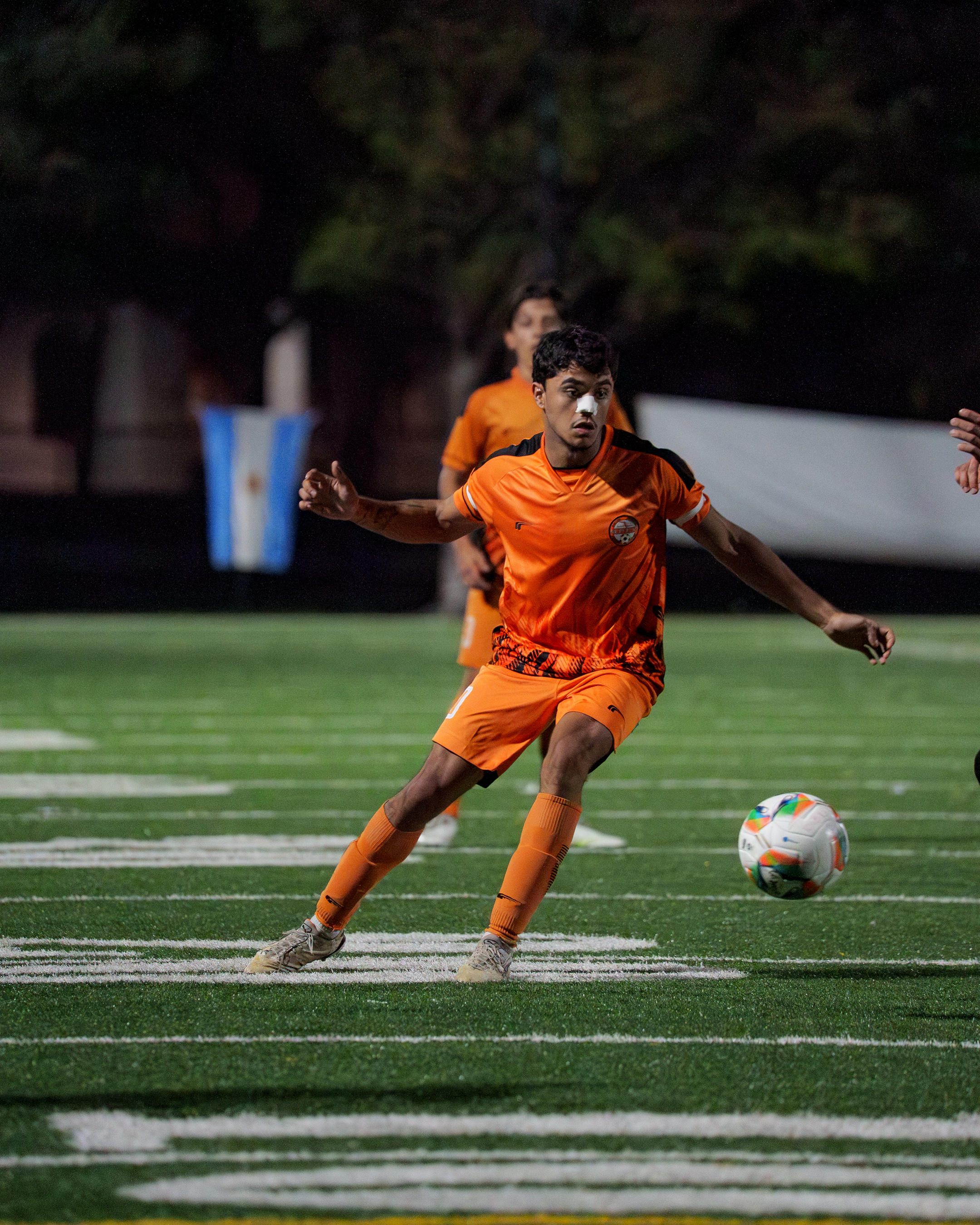 Teen soccer players practicing on the field.