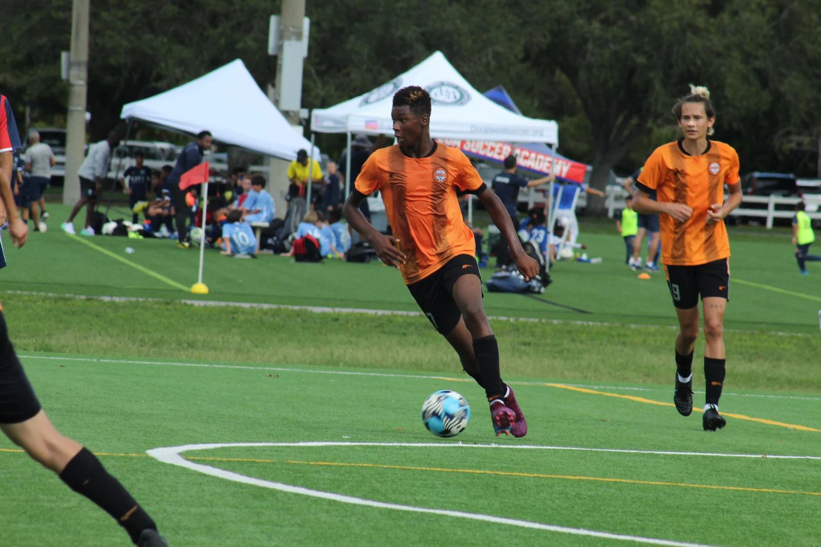 Adult players in action during a soccer match.
