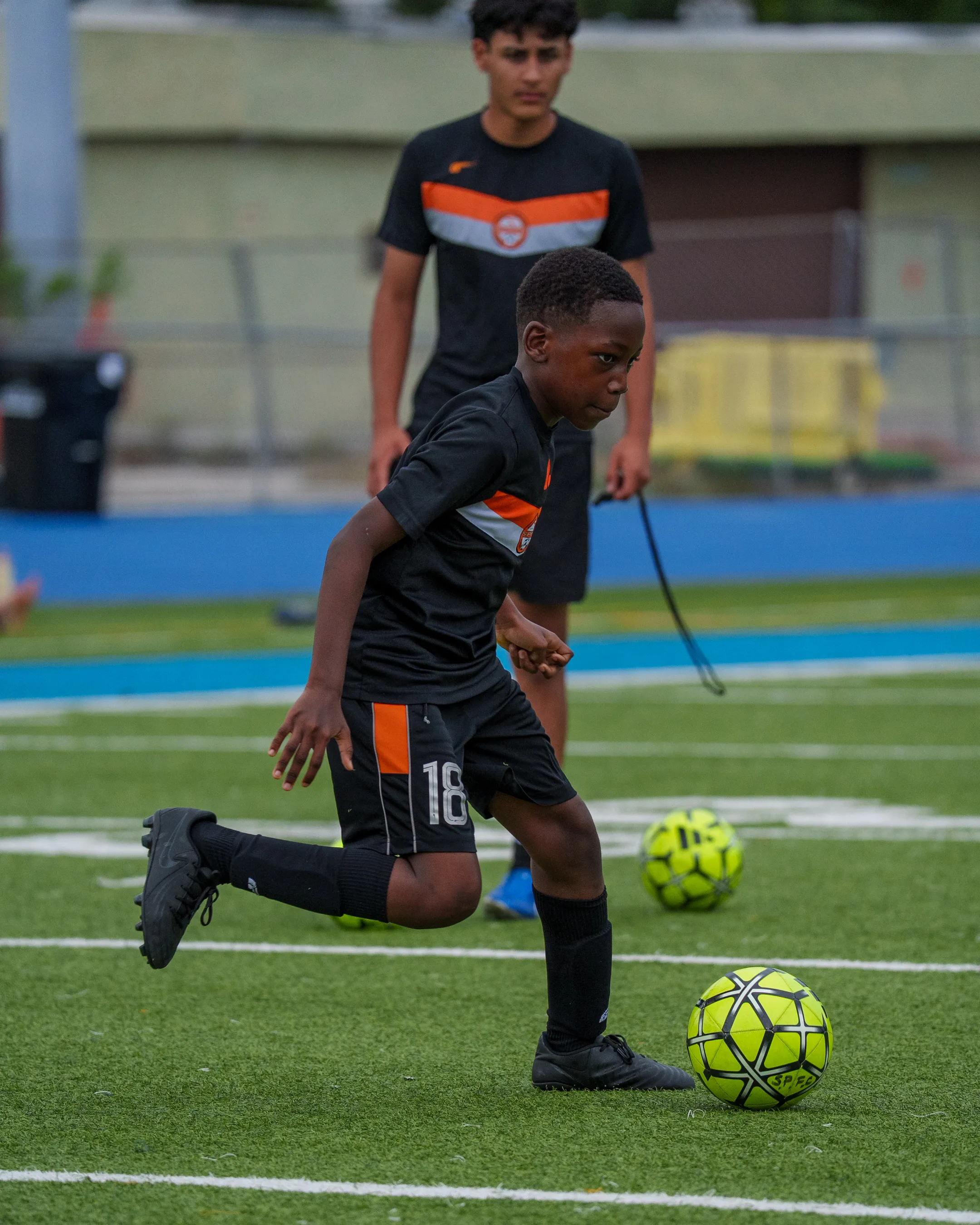 Young Soccer Paradise FC player dribbling the ball at training