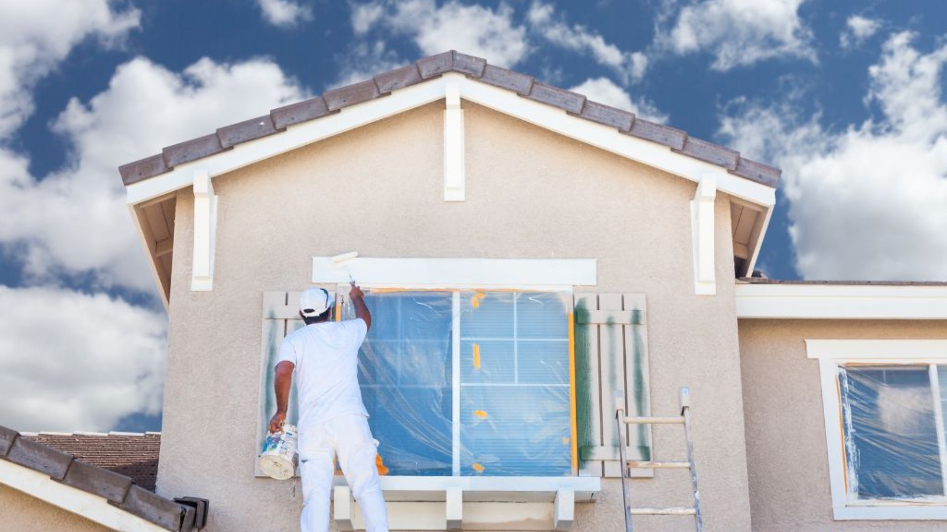 Professional painter working on the exterior of a Florida home
