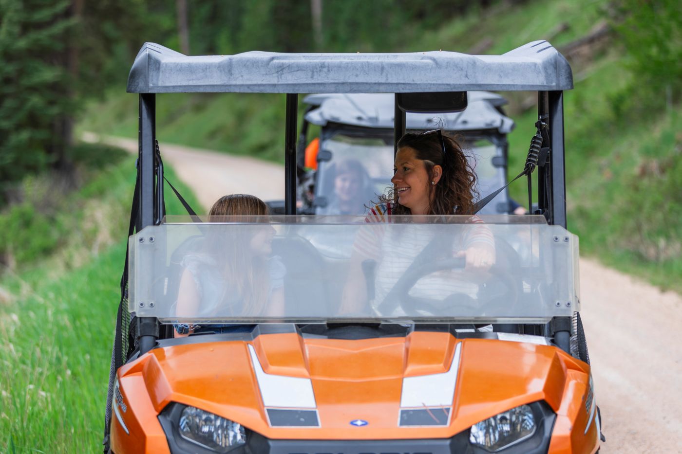 Guests riding UTVs on forest trails near Wickiup Cabins in the Black Hills.