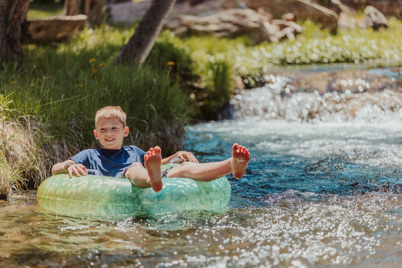 A guest tubing on Spearfish Creek at Wickiup Cabins.