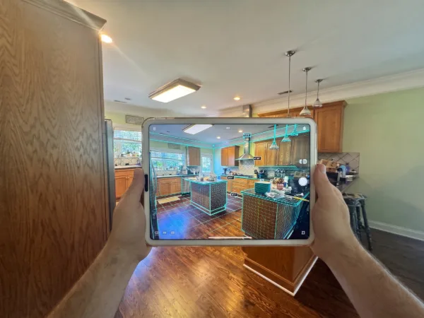 Sebring designer using a tablet to 3D scan an existing kitchen in Franklin, Tennessee