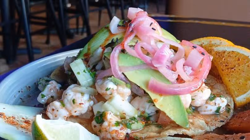 A plate of food with a slice of lime on top.