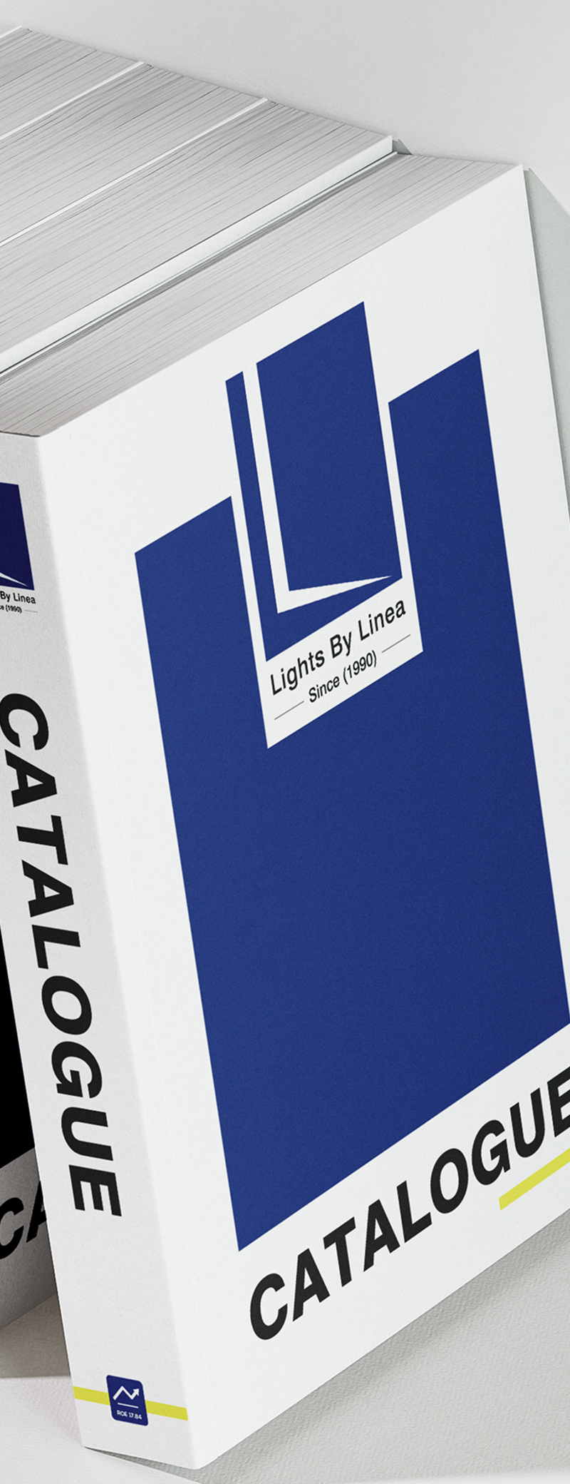 Catalogue book with blue geometric design and text 'Lights By Linea Since 1990' on white cover.