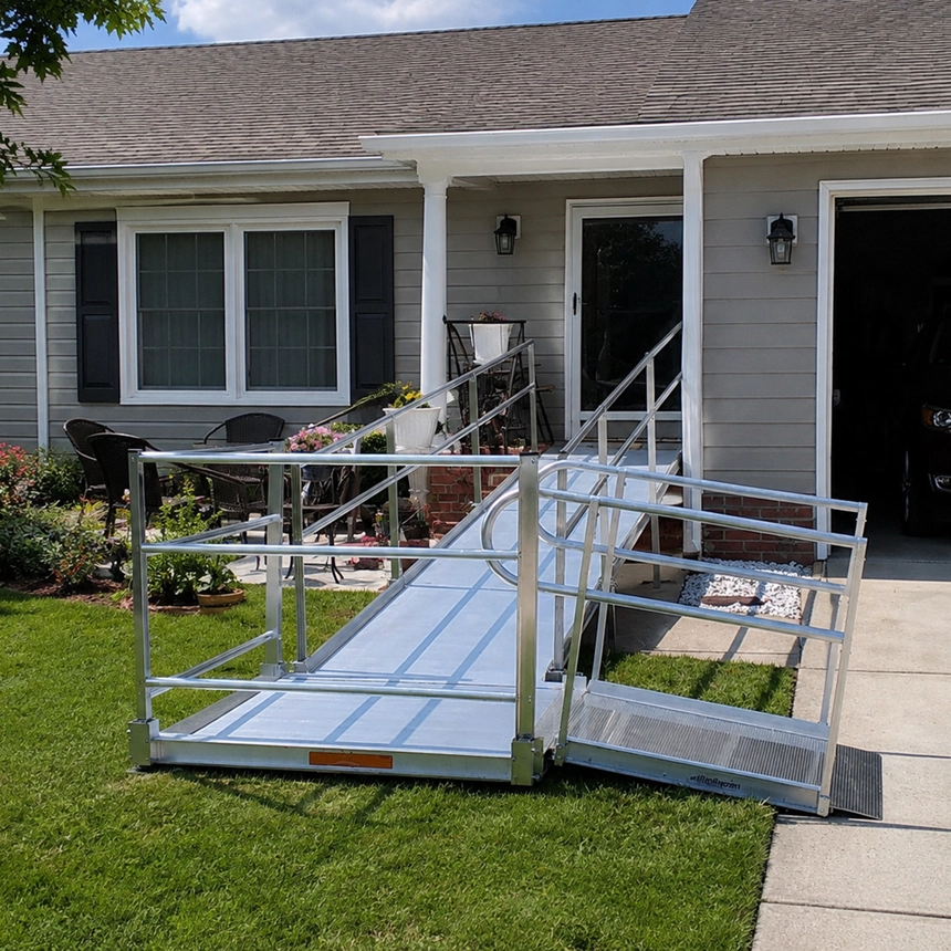 Aluminum modular wheelchair ramp installed at a home entrance by Simple Comforts.