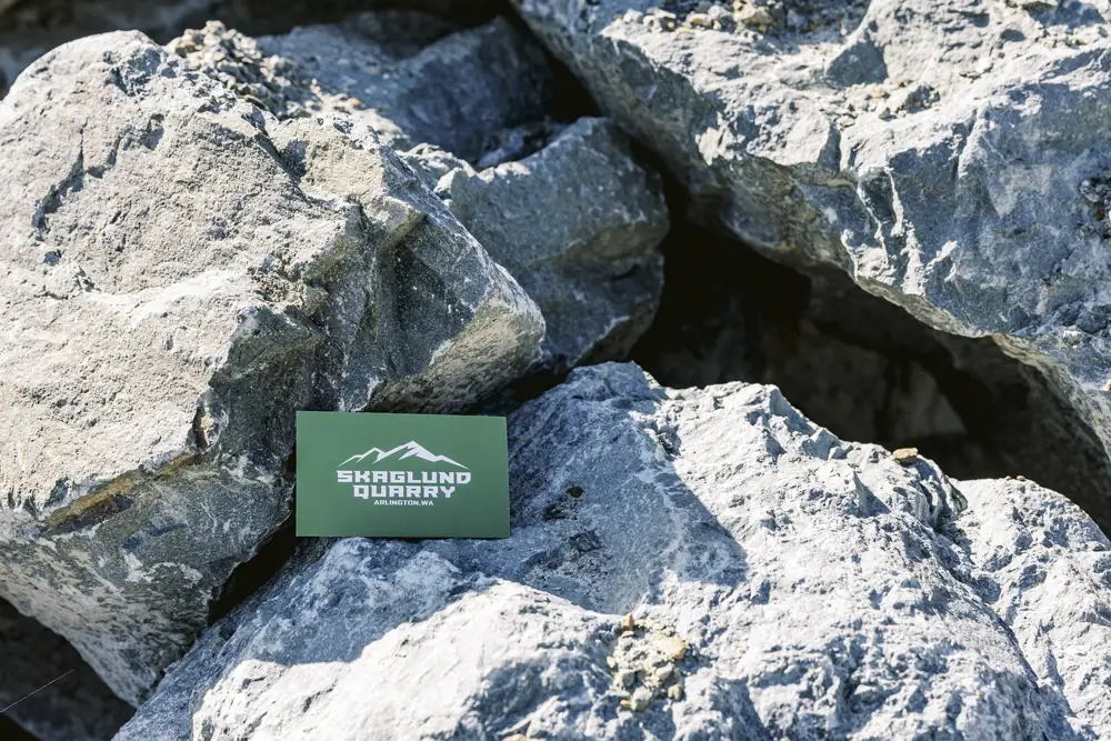 One man rocks with business card in photo for size reference | Skaglund Quarry | Arlington, WA