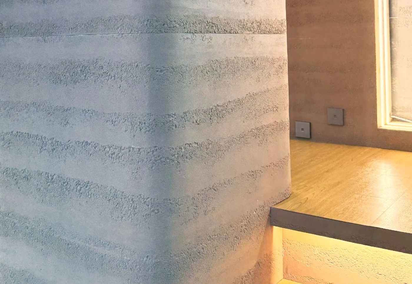 Ultra-thin stone veneer wrapping a curved column