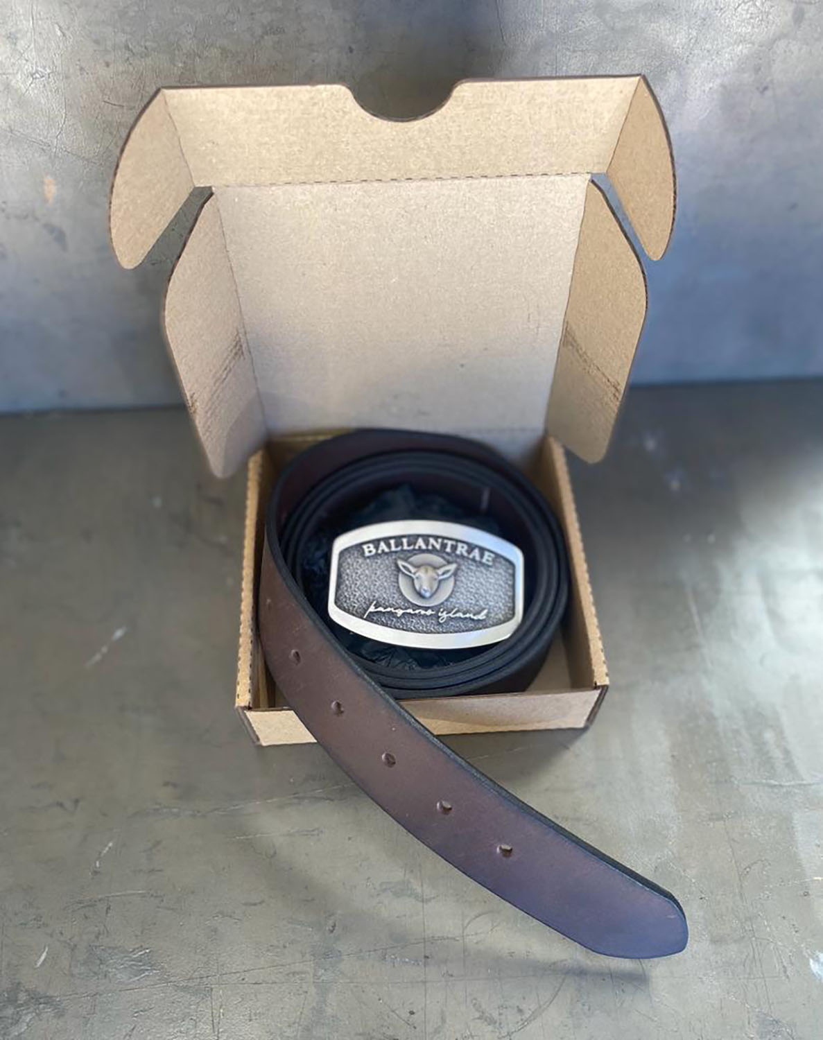 Australian made custom belt buckle presented in recyclable packaging with leather belt