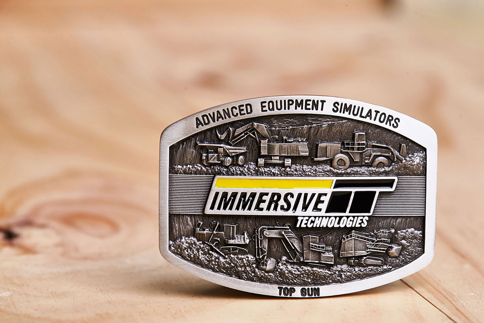 Immersive Technologies branded commemorative belt buckle featuring mining simulator artwork