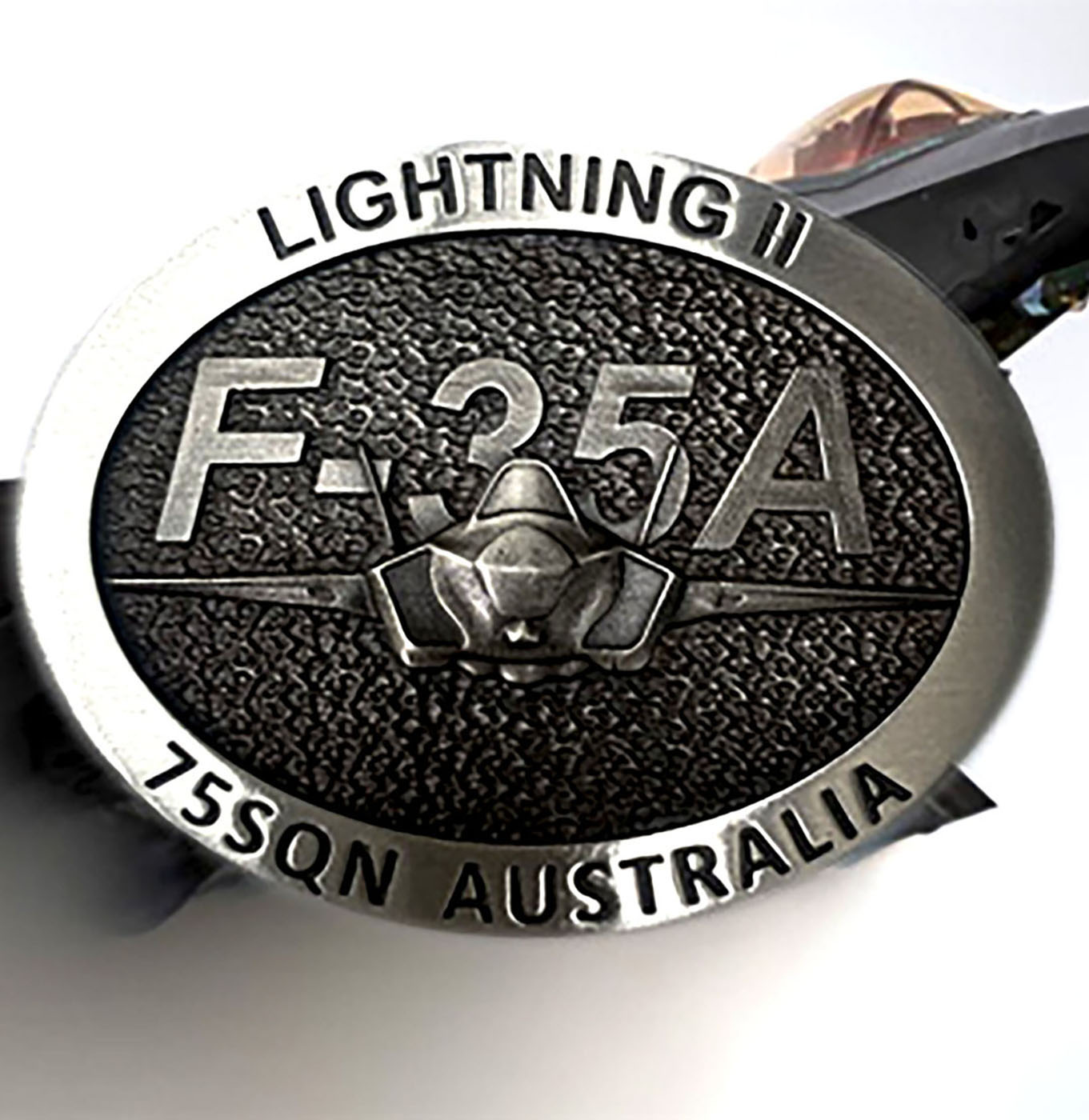 RAAF commemorative belt buckle featuring F-35A aircraft artwork