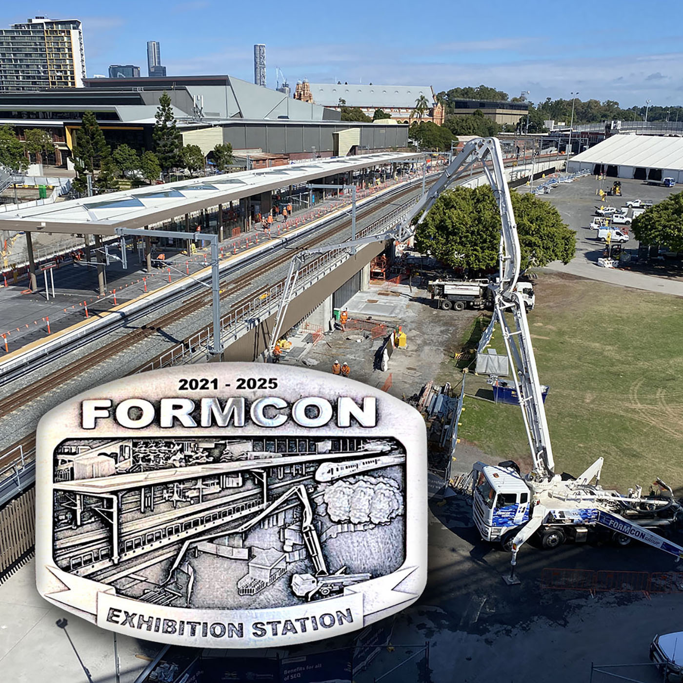 Formicon exhibition station commemorative belt buckle featuring large scale construction project artwork